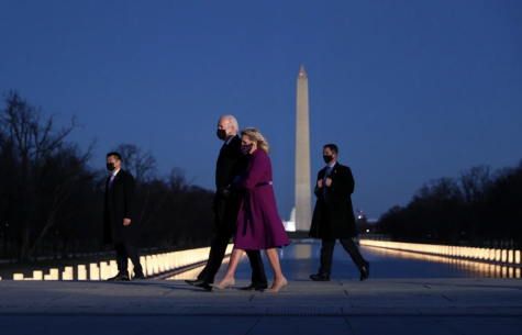 President Joe Biden and his wife Dr. Jill Biden walk together in front of the Washington Monument. The area was transformed into a memorial for the Americans who died during due to the Coronavirus.