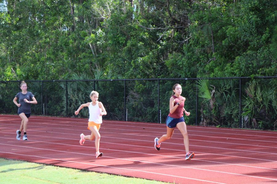 Cross country runners lap the track during August practices.