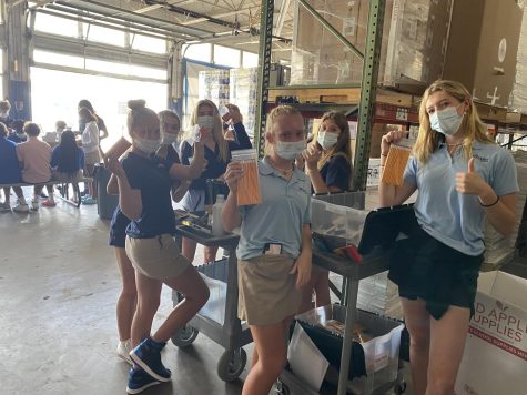 Several sophomore girls pose with pencils as they package them during their
community service event on Oct. 13. The sophomore class made its way to Red
Apple Supplies to help the community after taking a long, hard PSAT.
