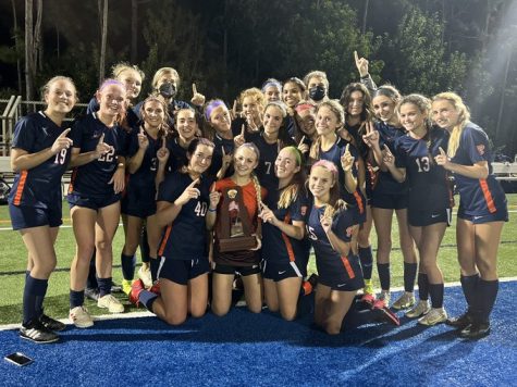 The girls' varsity soccer team celebrates its district championship.