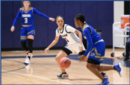 Junior Tay Blackshear works hard on defense during a recent game against the Martin County Tigers. 