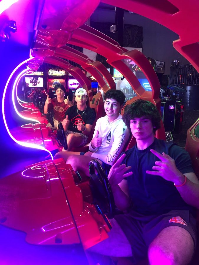 Juniors Ben Swank, Nick Banner, Luca Balzano, and Nick Wolf take a quick picture before facing off in an epic video-game race during their Re-Orientation Day visit to Fun Depot. 