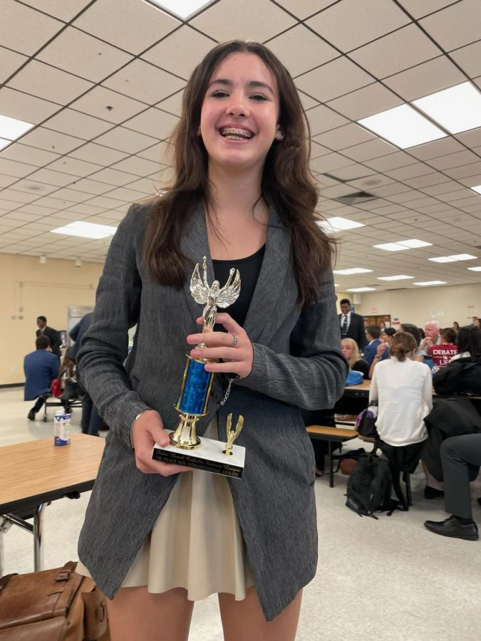 Freshman Kaia Huttenlocher beams after winning a trophy for her performance at the opening debate of the 22-23 season.