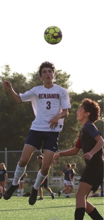 Zach Neidoff leaps to head a ball while playing Dwyer for the Varsity Benjamin Soccer team.  
