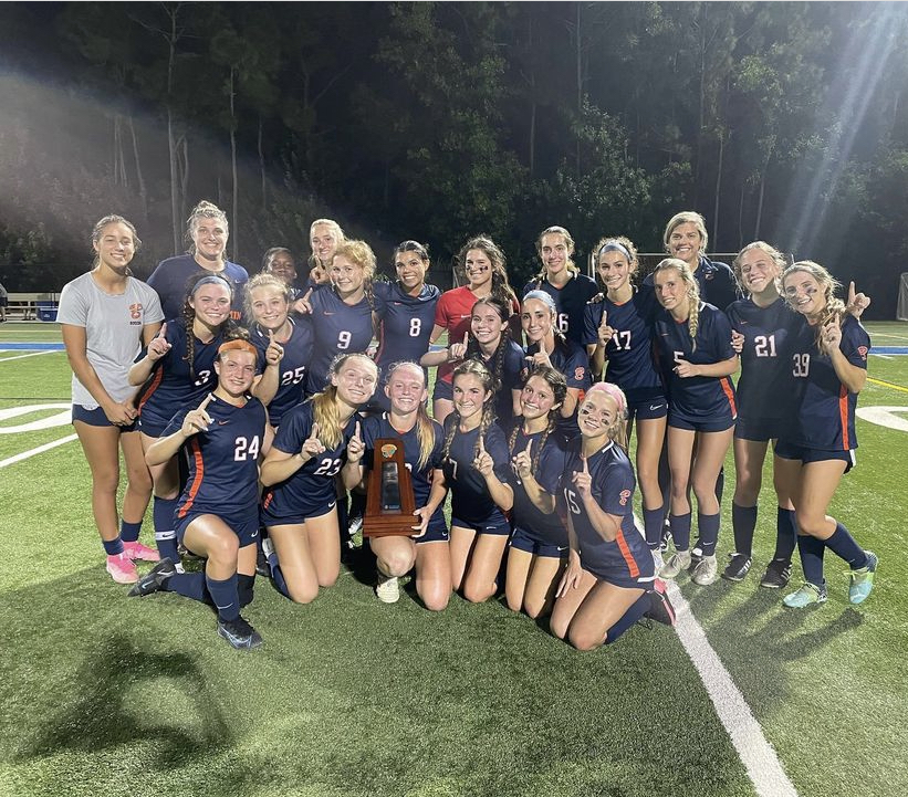 The+Girls+soccer+team+poses+for+a+picture+with+their+District+Championship+trophy.+The+team+defeated+Cardinal+Newman+2-0+at+home.+Although+the+team+was+thrilled+to+win+Districts%2C+they+have+bigger+aspirations+for+their+journey+to+the+State+Final.+