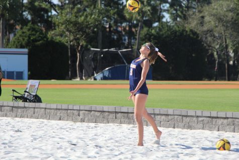 Junior Maggie Smith serves to the opposing Tigers in the first set during the beach volleyballs preseason game. She and sophomore Leanna Spada would dominate the first set 21-5 and ultimately win in three sets.
