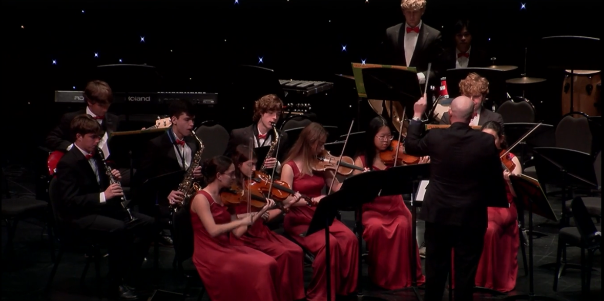 Dr. Henderson conducts the Upper School band during the annual holiday assembly