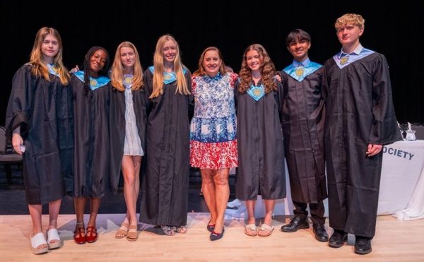 NHS Advisor Ms. Sara Misselhorn poses with student leaders at the spring induction ceremony.