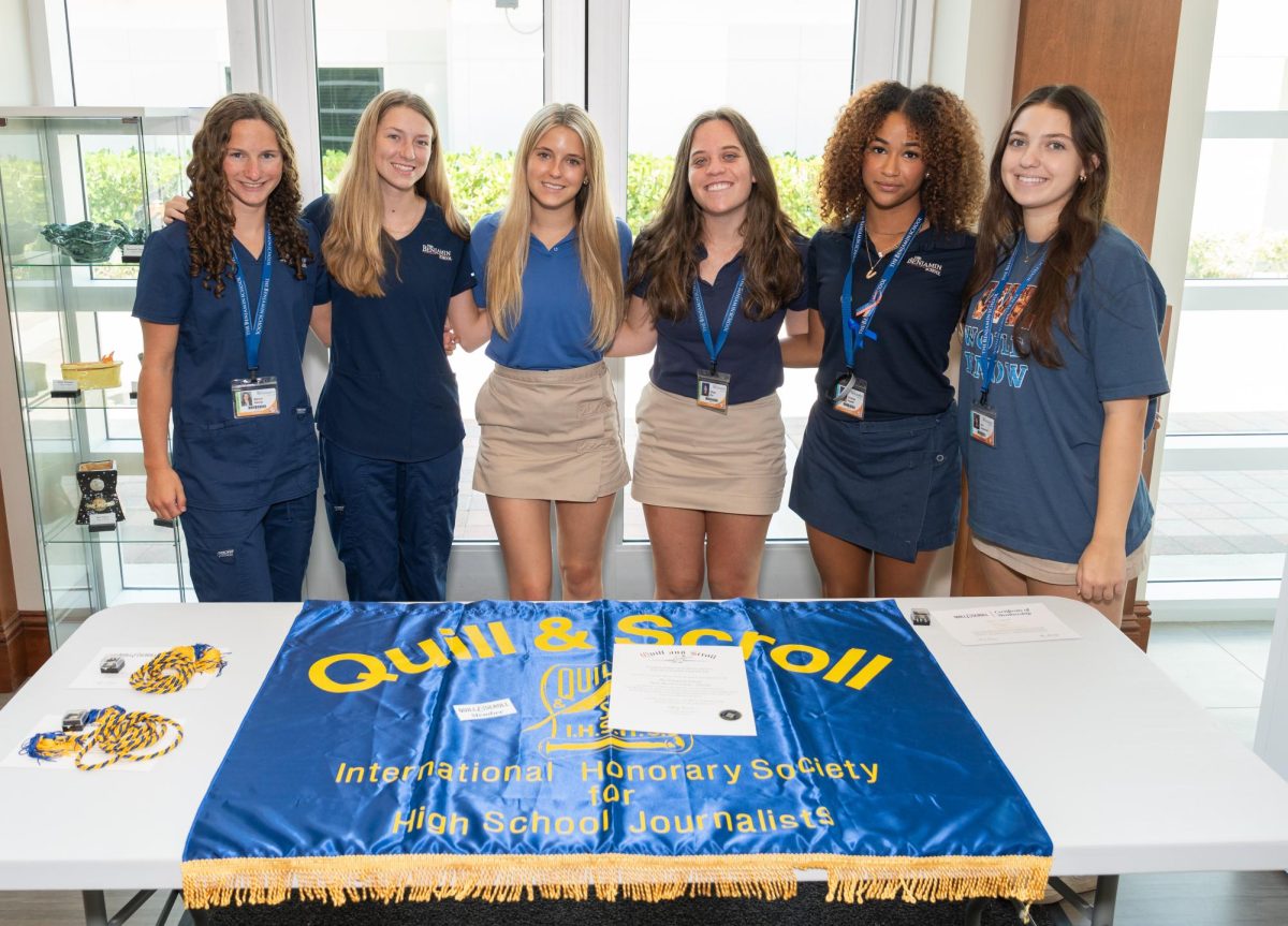 Six of this year’s ten inductees into the Quill and Scroll Society gathered around
the group’s banner and charter to mark their achievement. There have been 30
Benjamin inductees since the chapter received its charter in 2021.