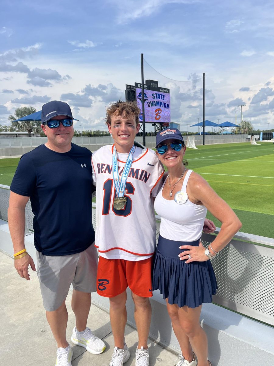 Senior Caleb Arwood celebrates the
team’s win with his proud parents.
Many families and friends made the
trip to Naples for the game.
