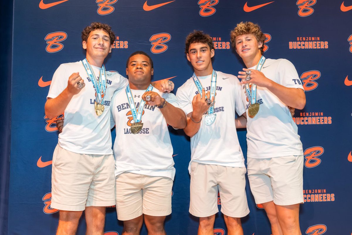 Seniors Jake Froot, Terrion Ivy-Atkins, Tatum Little, and Chase Conner pose for a photo with their State Champion rings and medals. 