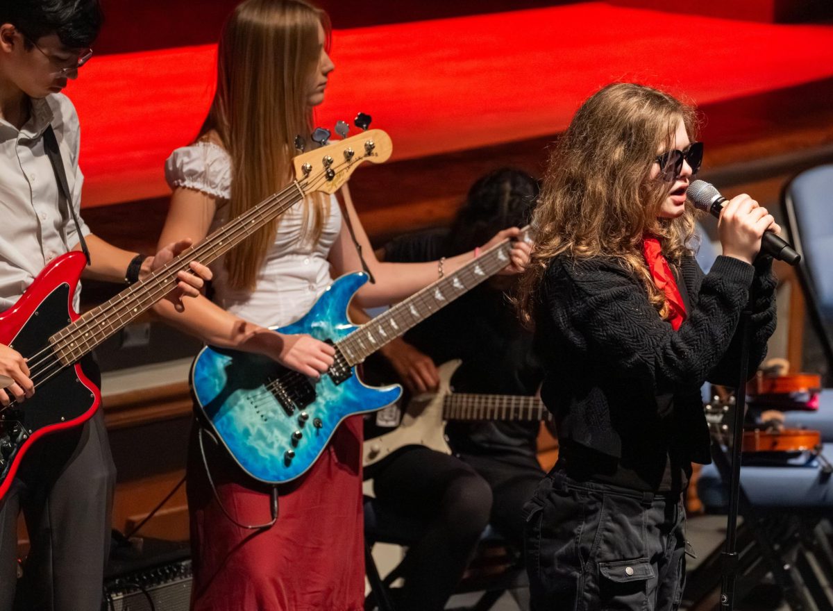 Freshman Emma Woody leads senior Matti Simonet and junior Katelyn Webster in performing "Californication" by the Red Hot Chili Peppers