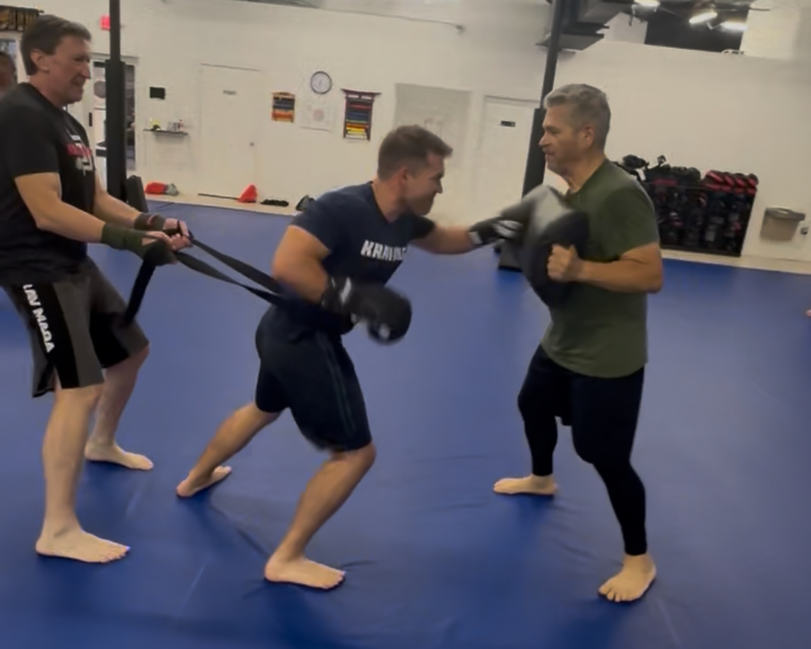 Mr. Connor Boray participates in a drill with his coaches at Hwang's Martial Arts