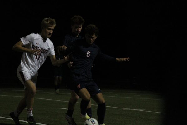 Junior Daniel Reznik makes a tough pass to his teammate in the first half of their 2-0 win against St. Andrews.