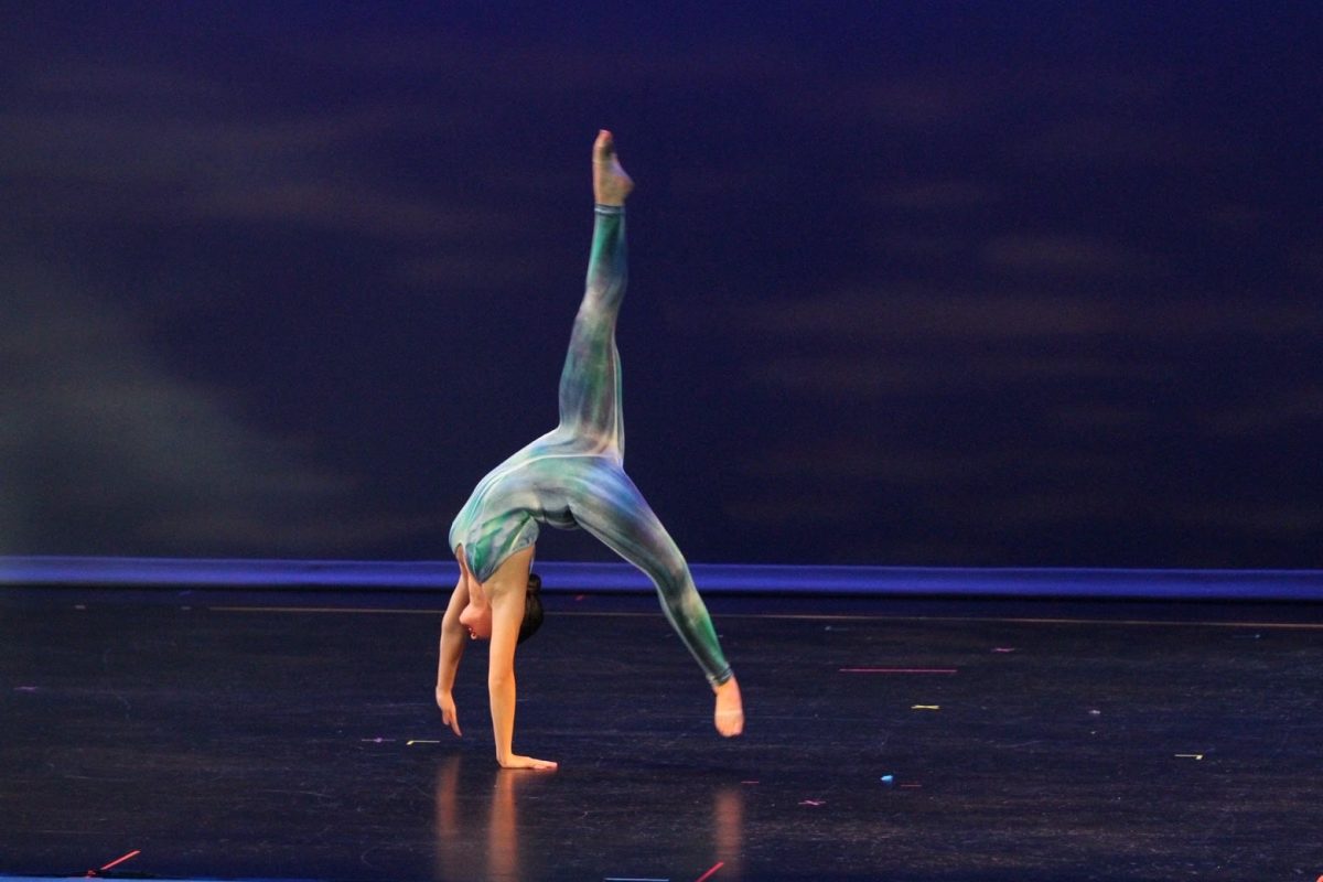 Senior Bryce Seger does a backhand spring in "My Solo Ocean."
