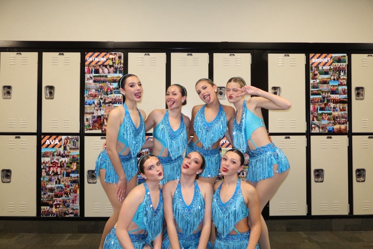 The Dazzlers pose before they go out and perform. 