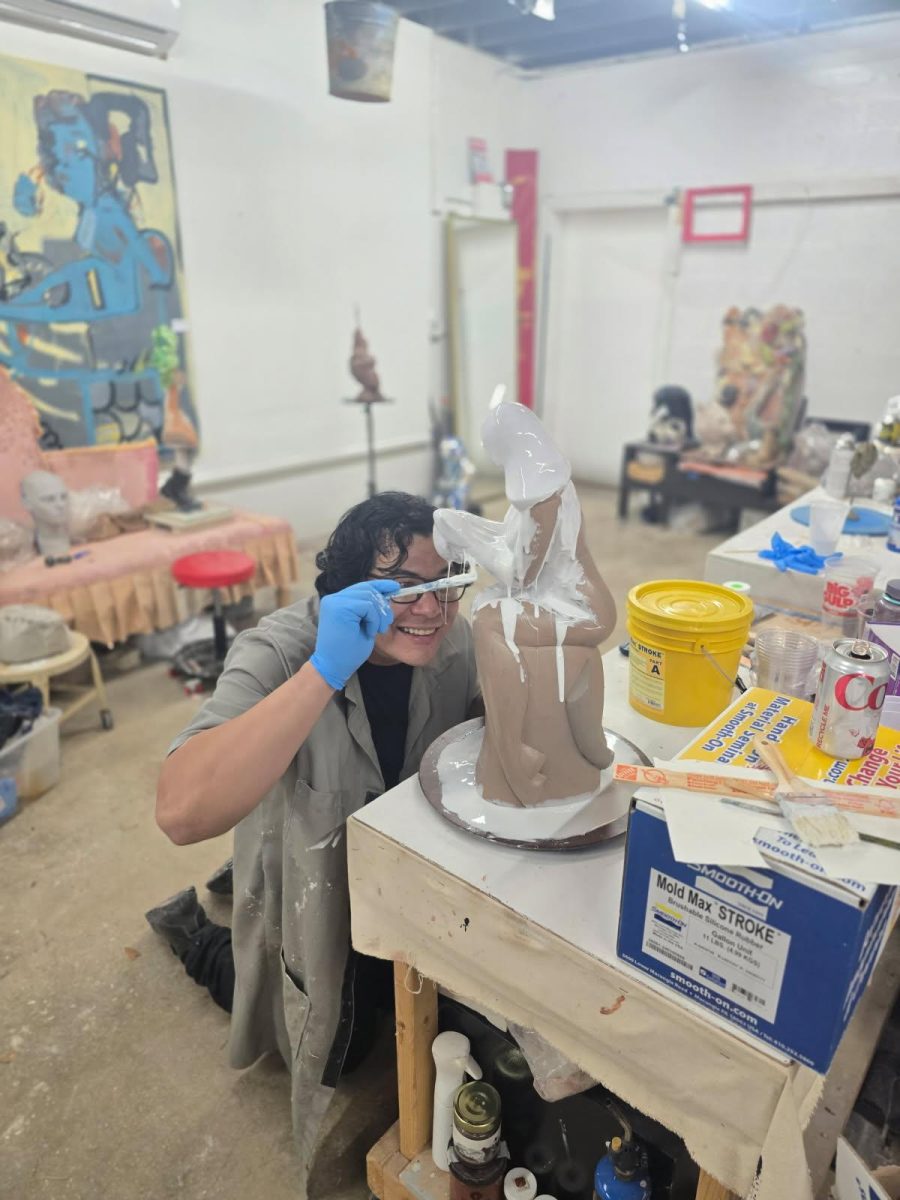 Mr. Mittman works on a sculpture. 